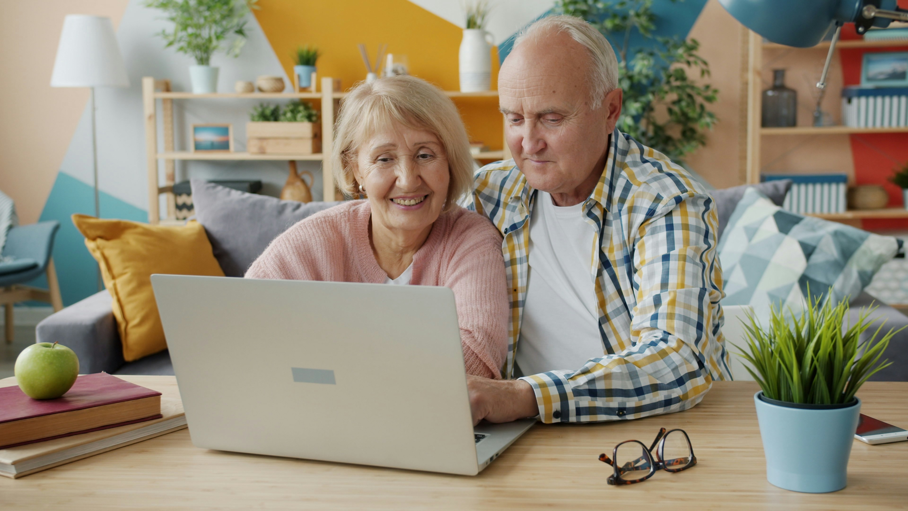 An older couple using a laptop together